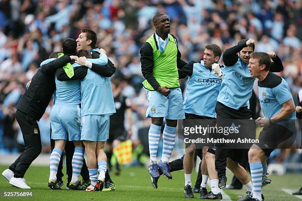 Micah Richards of Manchester City celebrates with some team mates as Sergio Aguero of Manchester City scores the winning goal