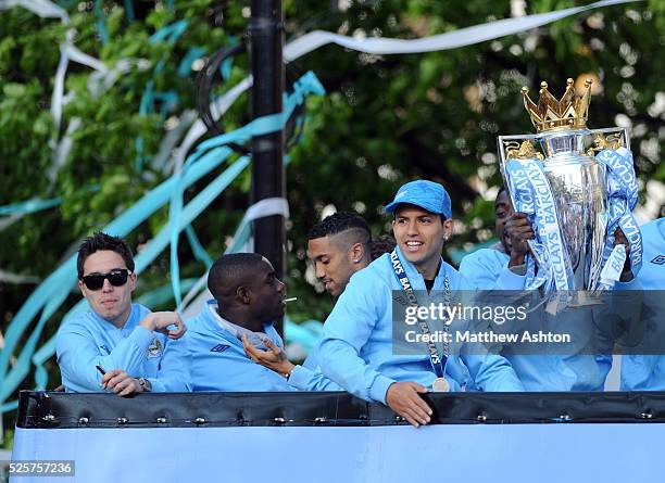 Sergio Aguero and Kolo Toure of Manchester City with the Trophy aboard a open-top bus to celebrate after winning the 2011-2012 Barclays Premier...