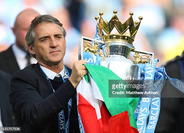 Roberto Mancini the head coach / manager of Manchester City with the Barclays Premier League Trophy