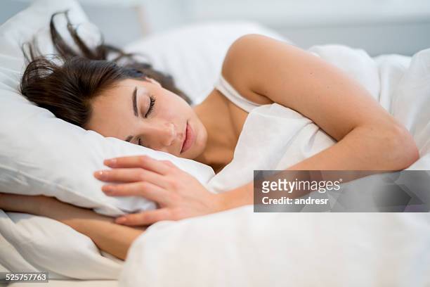 woman sleeping at home - bedding stock pictures, royalty-free photos & images