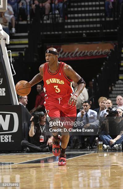 March 25: Al Harrington of the Atlanta Hawks dribbles against the San Antonio Spurs during the game at the SBC Center on March 25, 2005 in San...