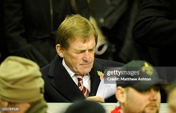 Former Liverpool player and manager, Kenny Dalglish studies his team sheet before kick off