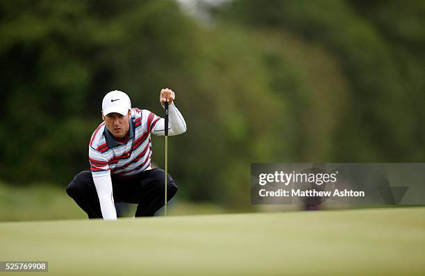 Ross Fisher of England replaces his ball