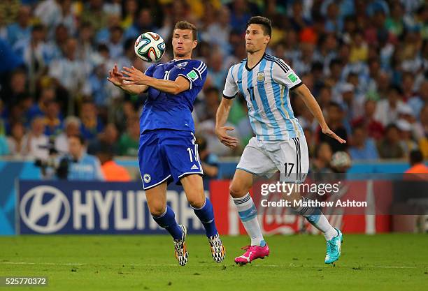 Edin Dzeko of Bosnia and Herzegovina and Federico Fernandez of Argentina