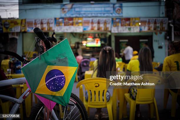 Fans gather around a television outside a bar in Gardenia Azul, Barra de Tijuca, Rio de Janeiro, Brazil for the FIFA World Cup 2014 to watch the...