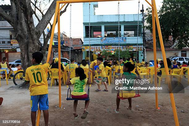 Fans gather around a television outside a bar in Gardenia Azul, Barra de Tijuca, Rio de Janeiro, Brazil for the FIFA World Cup 2014 to watch the...