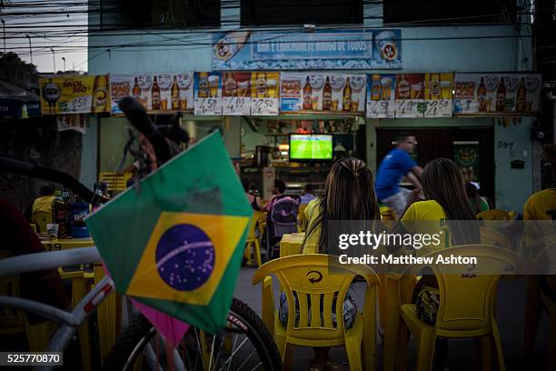 Fans gather around a television outside a bar in Gardenia Azul, Barra de Tijuca, Rio de Janeiro, Brazil for the FIFA World Cup 2014 to watch the...