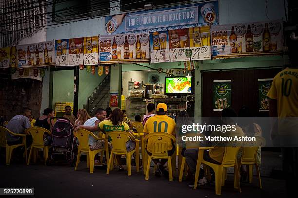 Fans gather around a television outside a bar in Gardenia Azul, Barra de Tijuca, Rio de Janeiro, Brazil for the FIFA World Cup 2014 to watch the...