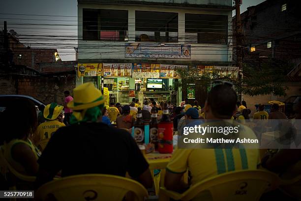 Fans gather around a television outside a bar in Gardenia Azul, Barra de Tijuca, Rio de Janeiro, Brazil for the FIFA World Cup 2014 to watch the...