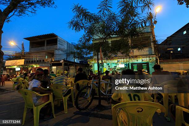 Fans gather around a television outside a bar in Gardenia Azul, Barra de Tijuca, Rio de Janeiro, Brazil for the FIFA World Cup 2014 to watch the...