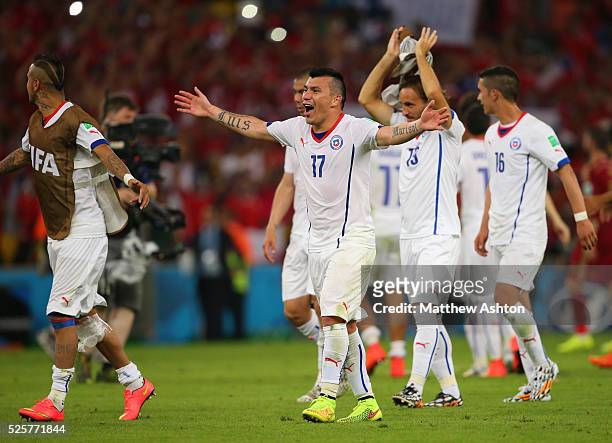 Gary Medel of Chile leads the celebrations at the end of the match which sees the defending champions Spain knocked out of the FIFA World Cup after...
