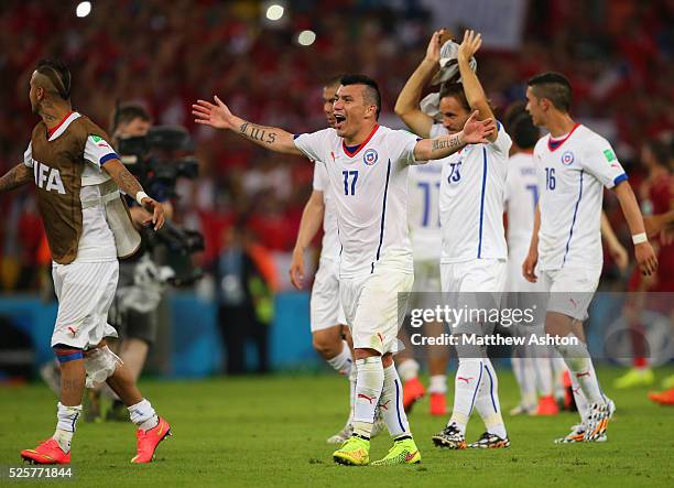 Gary Medel of Chile leads the celebrations at the end of the match which sees the defending champions Spain knocked out of the FIFA World Cup after...