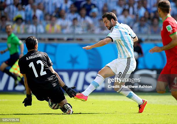 Gonzalo Higuain of Argentina sees his shot saved by goalkeeper Alireza Haghighi of Iran