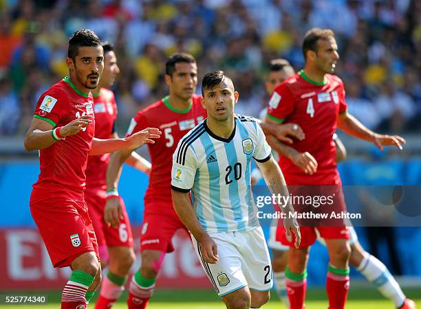 Sergio Aguero of Argentina is surrounded by Iran players including Reza Ghoochannejhad of Iran