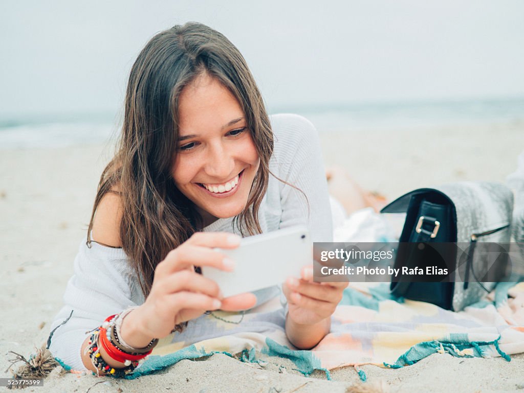 Pretty smiling woman using smartphone