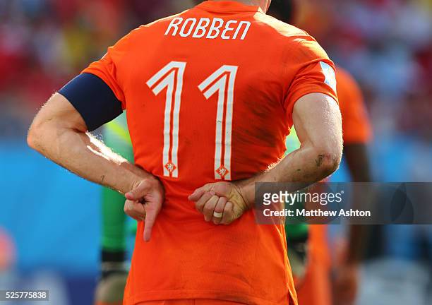 Arjen Robben of Netherlands indicates 1-0 to the fans behind his back