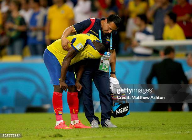 Dejected Walter Ayovi of Ecuador is consoled at the end of the match