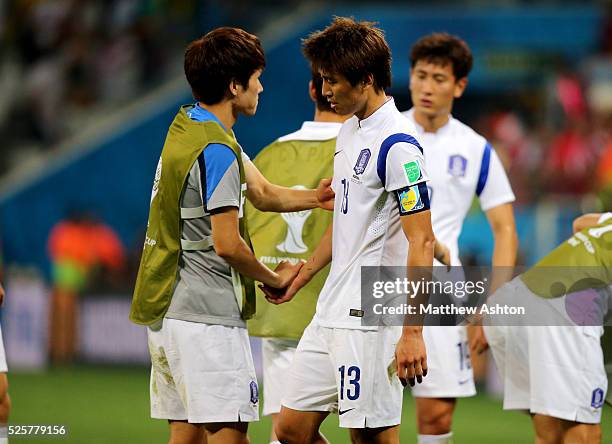 Dejected Koo Ja-Cheol of South Korea with his team mates after his team are knocked out the 2014 FIFA World Cup