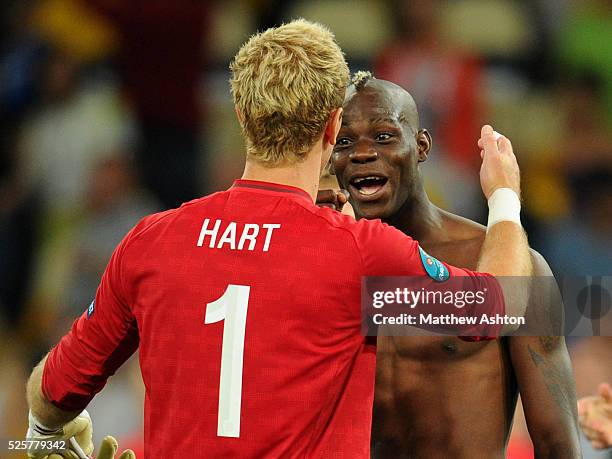 Joe Hart of England is confronted by a happy Mario Balotelli of Italy after winning the penalty shoot out