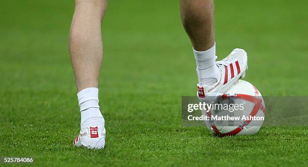 The football boots of David Beckham of England, with names of his childen Curz, Romeo and Brooklyn, resting on an official matchball