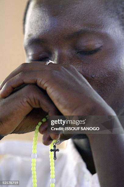 Man prays for Pope John Paul II at Notre Dame de la Paix basilica in Yamoussoukro, 02 Avril 2005. Pope John Paul II is drifting in and out of...