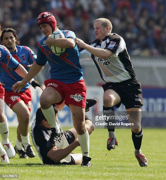 David Skrela, the Stade Francais standoff, is tackled by Mike McCarthy and Dave Walder during the Heineken Cup Quarter Final match between Stade...