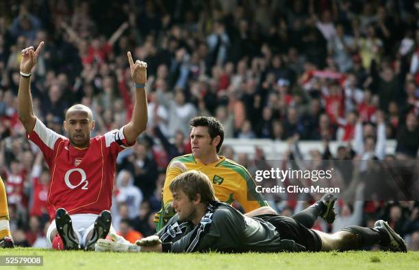 Thierry Henry of Arsenal points to the sky after scoing a hat-trick as the Norwich defence look on dejected during the Barclays Premiership match...