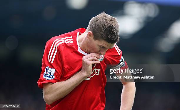 Steven Gerrard of Liverpool celebrates after scoring to make it 0-1 by kissing his badge