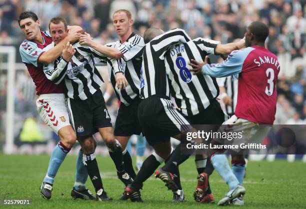 Gareth Barry of Aston Villa pulls apart Newcastle's Lee Bowyer and Kieron Dyer as they come to blows during the FA Barclays Premiership match between...