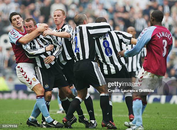 Gareth Barry of Aston Villa pulls apart the fighting Lee Bowyer and Kieron Dyer of Newcastle during the FA Barclays Premiership match between...