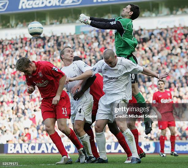 Scott Carson, the Liverpool goalkeeper, punches clear from Kevin Nolan and Kevin Davies of Bolton during the Barclays Premiership match between...