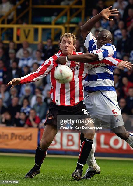 Chris Brown of Sunderland holds off Danny Shittu of Queens Park Rangers during the Coca-Cola Championship match between Queens Park Rangers and...