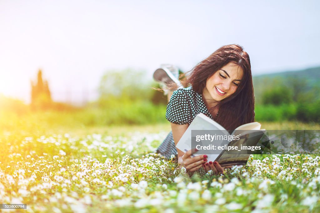 Beautiful girl reading a book