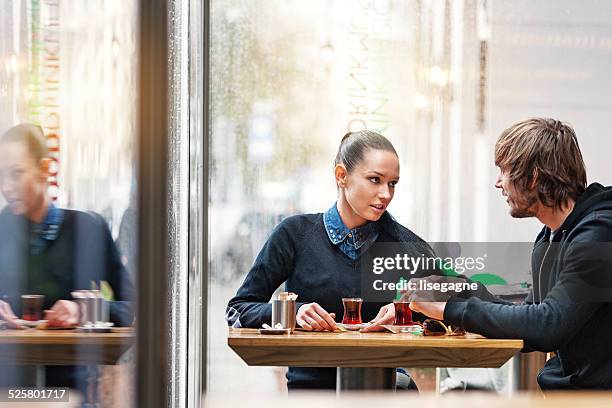 couple having turkish tea in a bistro - istanbul tea stock pictures, royalty-free photos & images