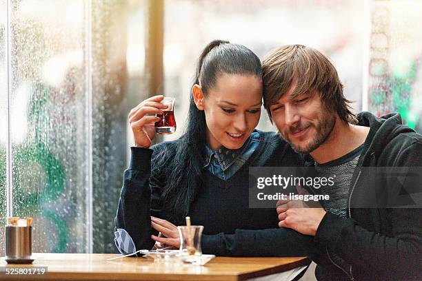 couple having turkish tea in a bistro - istanbul tea stock pictures, royalty-free photos & images