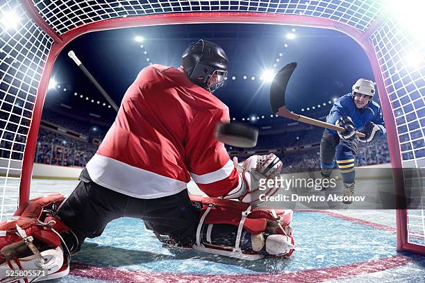 ice hockey player scoring - hockey puck stock pictures, royalty-free photos & images