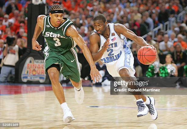 Raymond Felton of the North Carolina Tar Heels runs hard up the court against Shannon Brown of the Michigan State Spartans during the second half of...