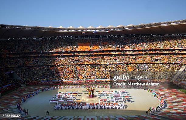 The flags of the participating countries are held up during the opening ceremony of the 2010 FIFA World Cup at Soccer City, Johannesburg