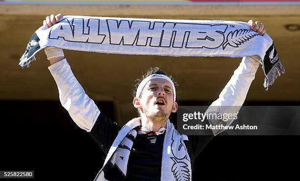 New Zealand fan holds up a scarf saying All Whites