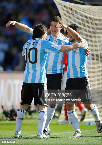 Lionel Messi of Argentina celebrates with Gonzalo Higuain of Argentina and Sergio Aguero of Argentina after the third goal
