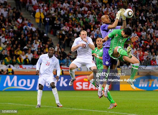 Wayne Rooney of England looks on as goalkeeper Rais M Bolhi of Algeria saves the ball