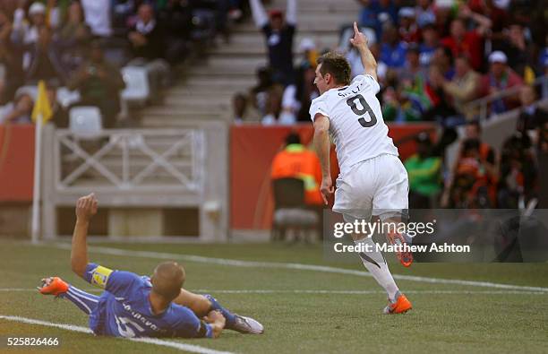 Shane Smeltz of New Zealand runs off to celebrate after scoring to make it 0-1 leaving Fabio Cannavaro of Italy lying on the pitch