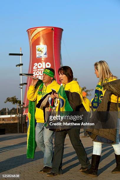 Brazil fans walk past a cooling tower on the way to the Soccer City stadium in Johannesburg