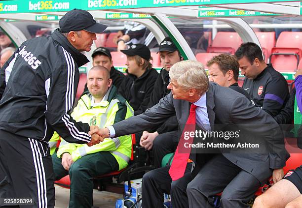 Tony Pulis head coach / manager of Stoke City shakes the hand of Arsene Wenger manager of Arsenal before the match