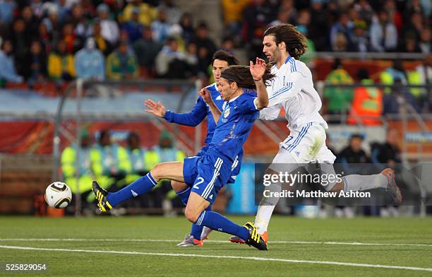 Martin Demichelis of Argentina beats Georgios Samaras of Greece to the ball