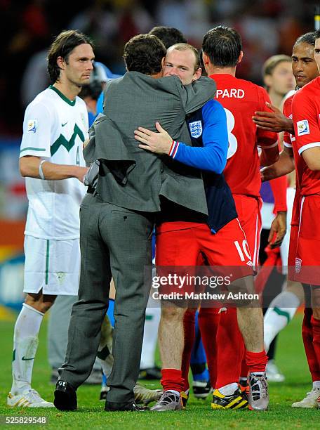 Fabio Capello manager / head coach of England hugs Wayne Rooney of England after the 0-1 victory over Slovenia