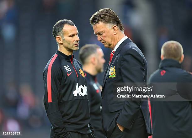 Dejected looking Louis van Gaal the head coach / manager of Manchester United and Ryan Giggs assistant coach of Manchester United