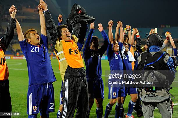 Japan celebrate after defeating Denmark 1-3