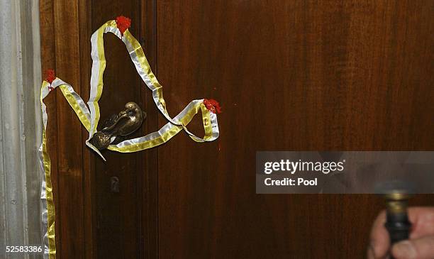 Cardinal Martinez Somalo seals the door of Pope John Paul II's private apartment on April 3, 2005 in Vatican City. The seal will be broken only when...