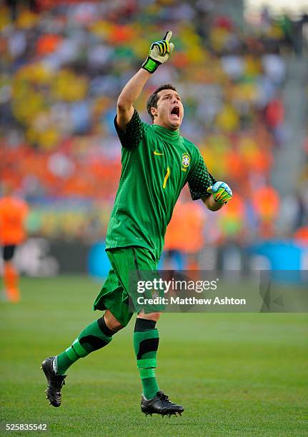 Goalkeeper Julio Cesar of Brazil celebrates after Robinho scored a goal to make it 1-0